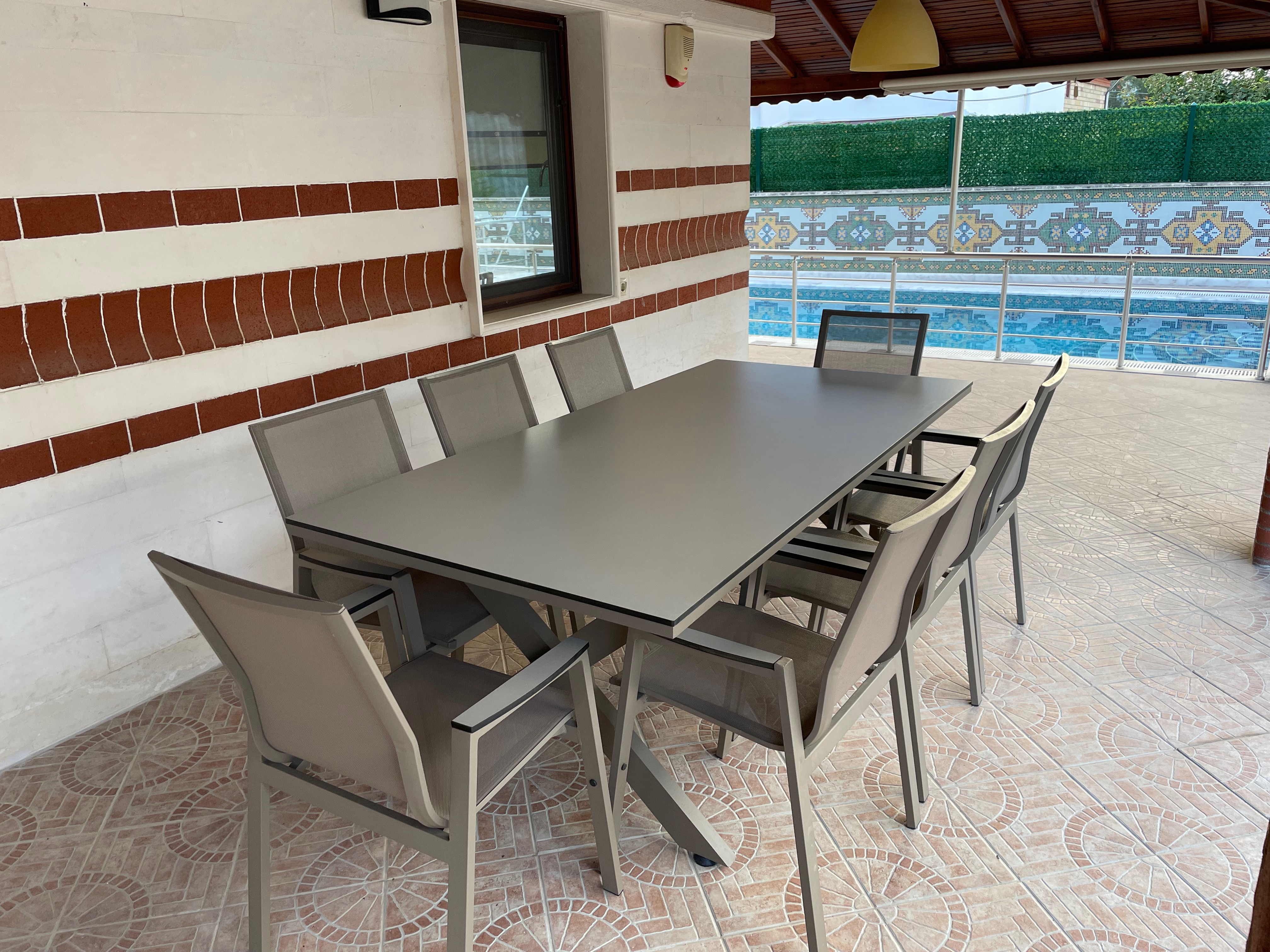 Outdoor terrace with pool and dining table